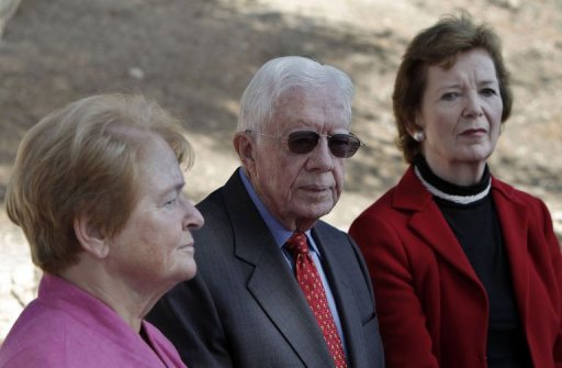 Former US president Jimmy Carter (C), former president of Ireland Mary Robinson (R) and former prime minister of Norway Gro Harlem Brundtland (L) listen to a guide as they tour East Jerusalem, on October 22, 2012, during the second day of a visit by "The Elders", a group of global leaders focused on human rights. AFP PHOTO /AHMAD GHARABLI