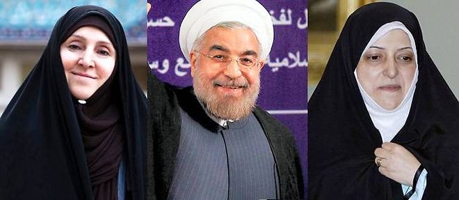 Le nouveau president iranien Hassan Rohani entoure de la nouvelle porte-parole de la diplomatie, Marzieh Afkham (a gauche), et de la nouvelle vice-presidente chargee de l'environnement, Massoumeh Ebtekar (a droite).