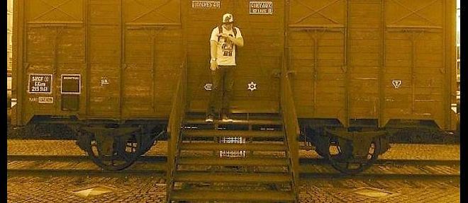A Drancy, un anonyme execute le salut de la quenelle devant un wagon ayant servi a deporter des juifs. Une photo qui temoigne du caractere antisemite de ce geste.