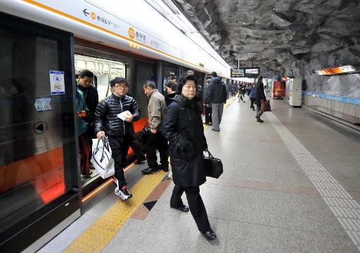 Des passagers descendent d'une rame du metro de Seoul le 24 janvier 2010