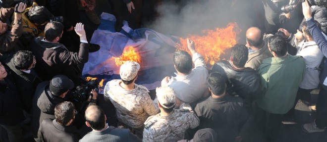 Des manifestants iraniens incendient un drapeau israelien lors des funerailles a Teheran du general Mohammad Allahdadi, tue dimanche lors d'un raid de Tsahal en Syrie.