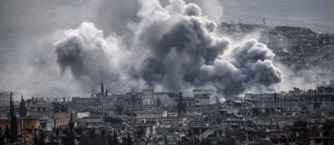 Des nuages de fumee emanent de la ville syrienne de Kobane apres un bombardement de la coalition contre l'EI, le 16 janvier 2015.