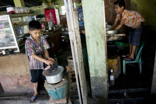 Saw Paing Htway (d) et Min Min, deux enfants qui travaillent dans un teashop (salon de the) a Rangoun, le 21 octobre 2015