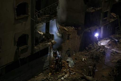 Des équipes de secours entrent dans un immeuble touché par des tirs de roquettes d l'armée syrienne, le 30 octobre 2015 à Douma © SAMEER AL-DOUMY AFP