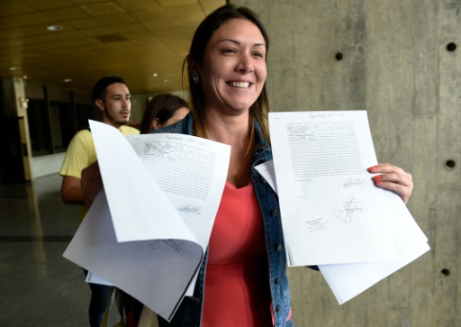 La député d'opposition venezuelienne Amelia Belisario montre des documents à la sortie de la Cour Suprême de Justice de Caracas, le 30 décembre 2015 © JUAN BARRETO -/AFP