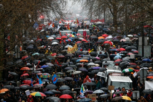 Des manifestants défilent sous la pluie à Paris, pour exiger le retrait du texte sur la réforme du travail © THOMAS SAMSON AFP