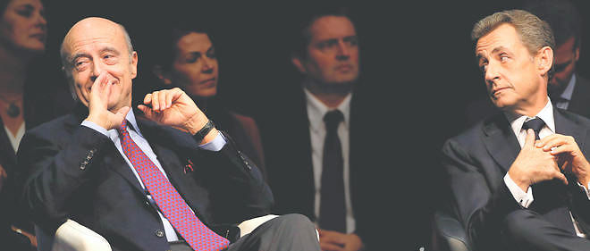 Nicolas Sarkozy et Alain Juppe lors d'un meeting de soutien a Virginie Calmels (candidate pour la droite aux elections regionales pour la region Sud-Ouest) a Limoges, le 14 octobre 2015. 