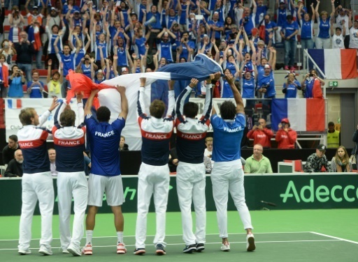 L'equipe de France de Coupe Davis agite un drapeau tricolore devant la tribune des supporters apres la victoire 3-1 face aux Tcheques, le 17 juillet 2016 a Trinec