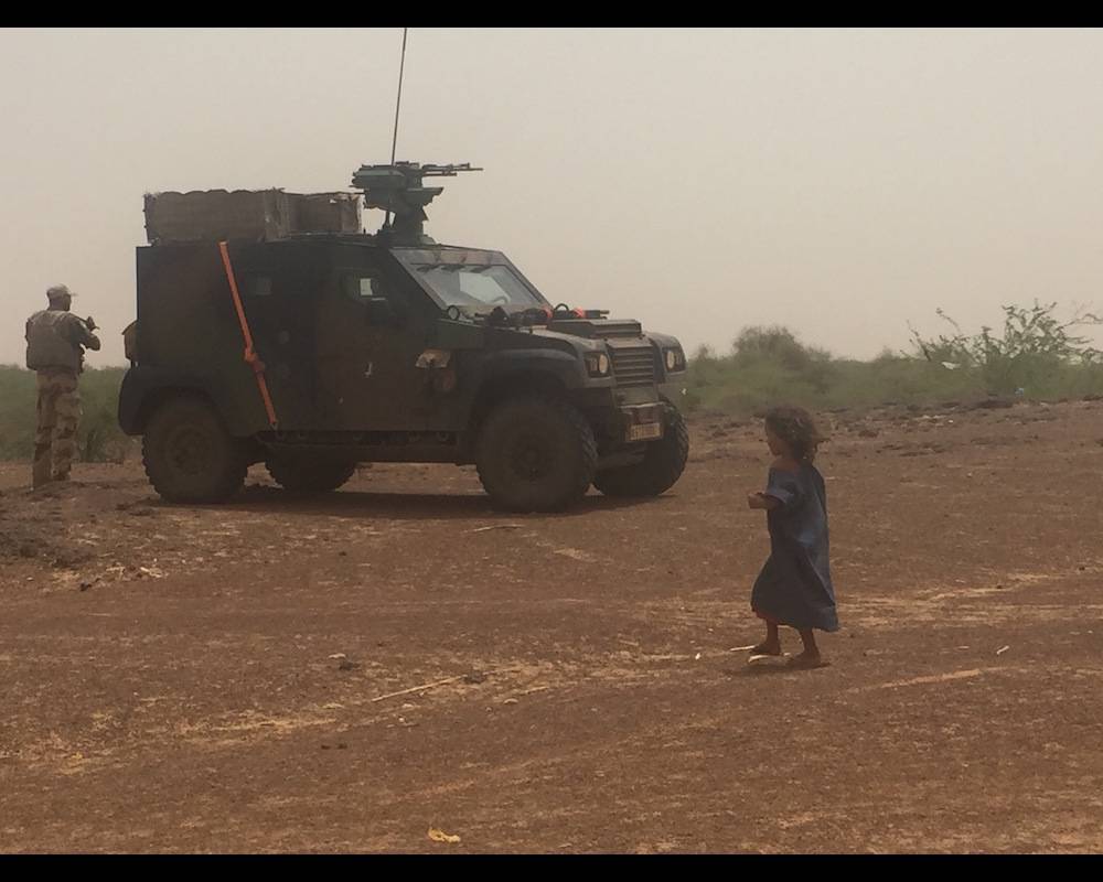 Une fillette malienne devant un véhicule blindé de l'opération française Barkhane dans la région de Gao, au Mali. ©  FX Freland
