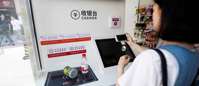 Dans une superette Auchan Minute en Chine. Aucun employe n'est present, les clients paient seuls a une caisse automatique.