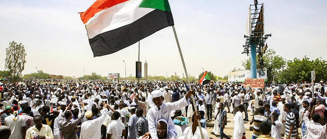 Un garcon soudanais brandit le drapeau national apres que le president Omar el-Bechir a ete demis. Khartoum, la capitale du Soudan, le 12 avril 2019. 