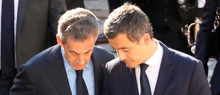 Gérald Darmanin et Nicolas Sarkozy dans une cérémonie.
