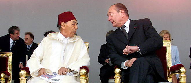 Le president francais Jacques Chirac parle avec le roi Hassan II du Maroc, invite d'honneur a la tribune officielle place de la Concorde, le 14 juillet 1999 a Paris, lors du traditionnel defile marquant la celebration du 14 juillet 1789. 
