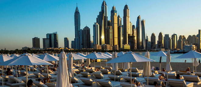 A beach in the Palm Jumeirah district offers stunning views of Dubai's skyscrapers.