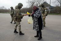 Une habitante de la région de Kherson donnant des provisions à un militaire russe (photo d'illustration).
