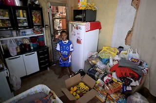 Miguel Barros dans sa maison de Santa Luzia avec les dons de nourriture reçus après avoir appelé la police à l'aide.
