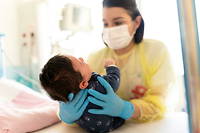 Une soignante s'occupe d'un bébé souffrant de bronchiolite dans un établissement de Bry-Sur-Marne, le 28 décembre 2021.
