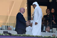 L'émir du Qatar, le cheikh Tamim bin Hamad al-Thani, serrant la main du président de la Fifa, Gianni Infantino, avant le match de football du groupe A de la Coupe du monde entre le Qatar et l'Équateur au stade Al-Bayt d'Al Khor, au nord de Doha, le 20 novembre.

