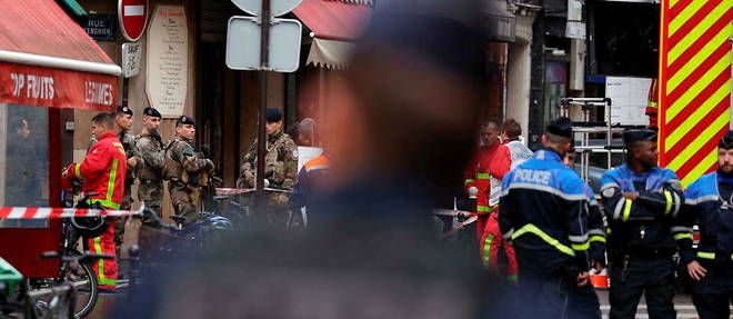 Les forces de l'ordre securisent une portion de la rue d'Enghien dans le 10e arrondissement de Paris, le 23 decembre 2022, apres que plusieurs coups de feu ont ete tires.
