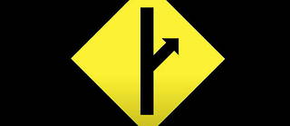 Le logo du mouvement masuliniste MGTOW. La signaletique indique un changement de voie. Il est possible d'y voir aussi une reference au sexe masculin.
