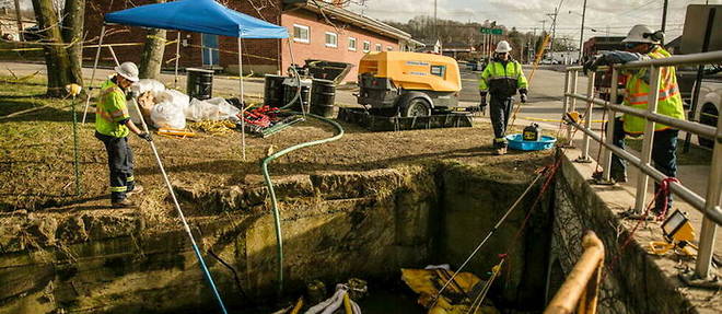 A crew works to clean up Sulfur Run, a creek that runs through the township of East Palestine, Ohio, on February 23, 2023. 
