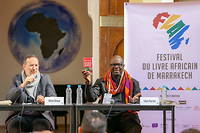 Le Docteur en sociologie de l'universite de Toulouse et professeur associe de l'universite de Rabat Mehdi Alioua (a gauche) et l'ecrivain, ancien international de football francais, Lilian Thuram, invites du Festival du livre africain de Marrakech.
