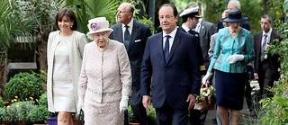 La reine Elizabeth II, le président Hollande, la maire de Paris Anne Hidalgo et le prince Philip visitent le marché aux fleurs, désormais nommé « marché aux fleurs de la reine Elizabeth II », dans le 4 e  arrondissement de Paris, le 7 juin 2014.
